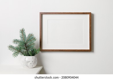 Frame Mockup With Copy Space For Artwork, Photo Or Print Presentation. White Wall With Christmas Tree. Minimalistic Style Interior.