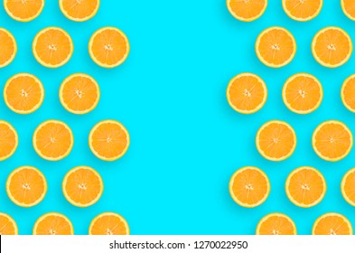 Frame of an orange citrus slices on bright blue background