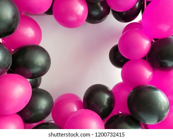 Frame With Pink And Black Balloons On White Background