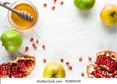 Frame of pomegranate, pomegranate seeds and apples with honey for the Rosh Hashanah - Powered by Shutterstock