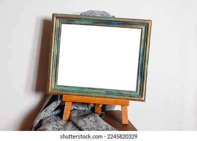 Frame in Provence style on an easel with drapery. Place to insert a picture - Shutterstock ID 2245820329