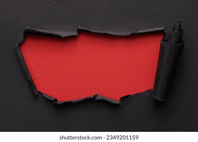 Frame of ripped paper with torn edges. Window for text with copy space red black colors, shreds of notebook pages. Abstract background
 - Powered by Shutterstock