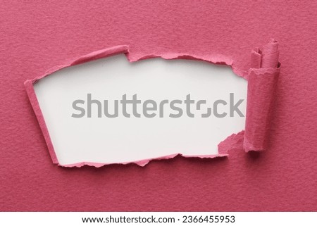 Frame of ripped paper with torn edges. Window for text with copy space red burgundy white colors, shreds of notebook pages. Abstract background
