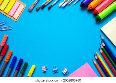 Frame From School Office Supplies. Colorful Pencils, Felt-tip Pens, Brushes, Stickers And Stationery Flat Lay On Blue Background. Back To School Concept.