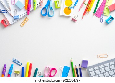 Frame of shcool supplies and keyboard on white background. Back to school, distance learning online concept. Flat lay, top view, overhead. - Powered by Shutterstock