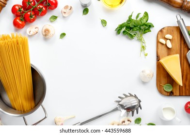 Frame With Spaghetti And Various Ingredients For Cooking Pasta On A White Background, Top View. Flat Lay