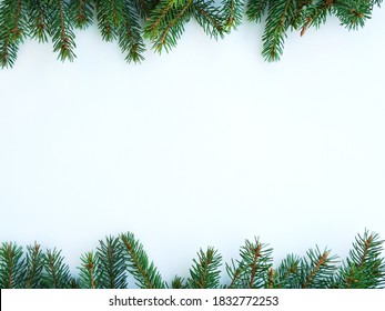 frame top and bottom of fir branches on a white background. High quality photo
