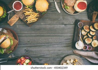 Frame from various food, burgers, salad, roquefort cheese and vegetables cooked on the grill, top view. Outdoors food Concept