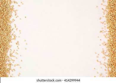 Frame from white quinoa on the white background, overhead horizontal view.Dry grains of gluten free cereal quinoa.