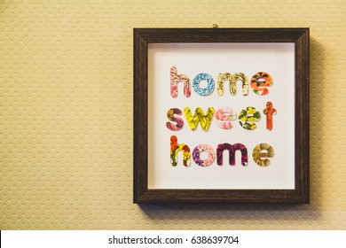 Framed letters home sweet home hung on a wall