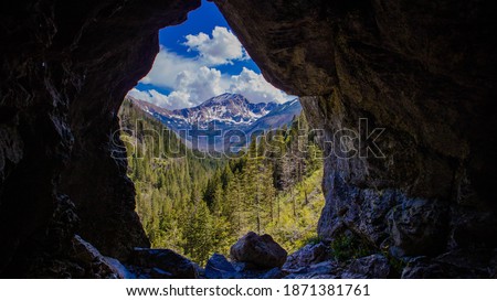 Framed mountain landscape from the inside of Mylna Cave (Jaskinia Mylna) in Koscieliska Valley in West Tatra Mountains, taken on beautiful summer day, Blyszcz and Bystra summits in the background
