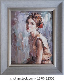 Framed oil painting. Portrait of a girl. The art is done in a realistic manner. 