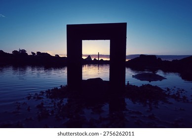 Framed sunset and reflections in a rock pool