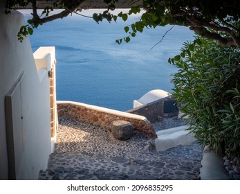 A Framed View On A Staircase Going Down To The Aegean Sea With No People. Taken At The End Of A Sunny Summer Day In The Aegean Island Of Santorini, Greece