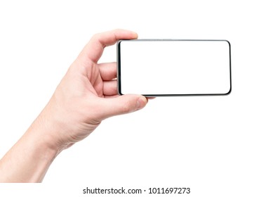 Frameless display on the phone. Modern technology in the hand of man. - Shutterstock ID 1011697273