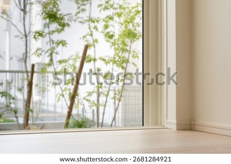 Frameless fixed window view overlooking small Japanese courtyard garden