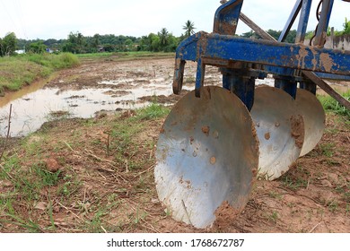 A Frameset Of Three Disc Plough Placed Beside The Rice Fields.