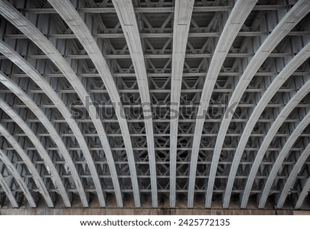 Framework metal arches girder construction Underneath of Blackfriars Bridge. View of Structure and beams under the Curved steel Bridge, Riveted steel beams supporting bridge span, Copy space. 