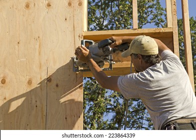 Framing Construction Contractor Installing Sub Siding On A Wood Frame Wall Of A New Luxury Custom Home