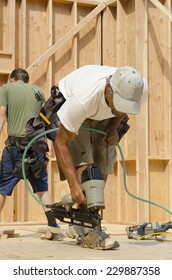 Framing Construction Contractor Installing Sub Siding On A Wood Frame Wall Of A New Luxury Custom Home