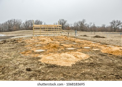 Framing For A Garage With Concrete Floor And Driveway.  Concrete Footings For A Manufactured Home To Be Put Next To The Garage.