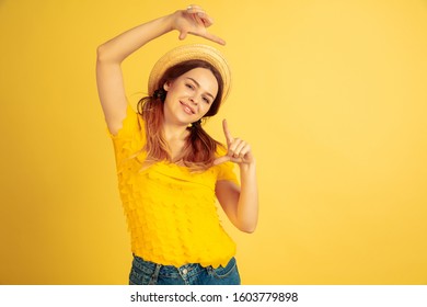 Framing, selfie, smiling. Caucasian woman's portrait on yellow studio background. Beautiful female model in hat. Concept of human emotions, facial expression, sales, ad. Summertime, travel, resort. - Shutterstock ID 1603779898