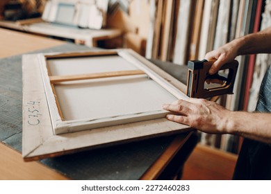 Framing Workshop assembling. Stapler ruler and frames baguette handmade picture frame at studio table