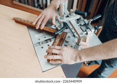 Framing Workshop. Assembling staples corners brackets baguette handmade picture frame at studio.