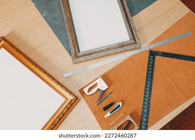 Framing Workshop. Stapler ruler and frames baguette handmade picture frame at studio table