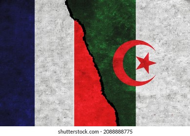 France and Algeria painted flags on a wall with a crack. France and Algeria conflict. Algeria and France flags together. France vs Algeria
