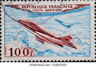 France - Circa 1954: A Postage Stamp From France, Showing The Dassault Mystère IV 100F Military Aircraft Above The Clouds In Flight With A Second Aircraft 