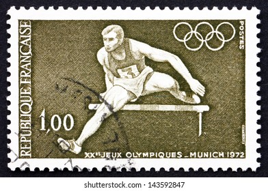 FRANCE - CIRCA 1972: a stamp printed in the France shows Hurdler and Olympic Rings, 20th Olympic Games, Munich, Germany, circa 1972