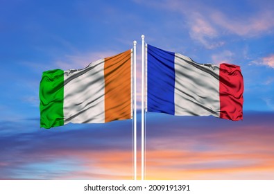 France and Cote d'Ivoire Ivory coast two flags on flagpoles and blue cloudy sky