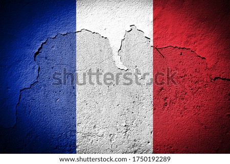 France flag painted on grungy cracked wall