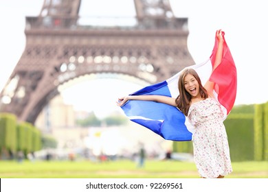 France - french flag woman by Eiffel tower, Paris. France travel concept with excited and happy young girl holding the French flag. - Powered by Shutterstock