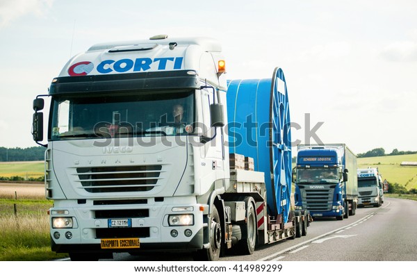 FRANCE, JUL 11, 2011: Convoi Exceptionnel -\
Special Transport truck driving on French road a special cable\
cargo with traffic jam\
behind