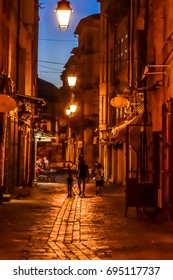 Uzès, France, July 2017
Father Walking With His Children In An Alley.