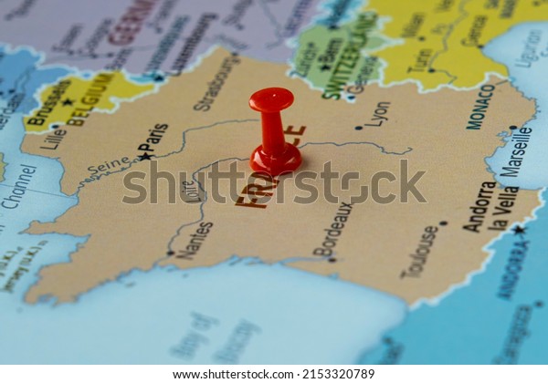 France location on a map with red\
thumbtack, travel idea, Paris and France on map with a red\
fastener, vacation and road trip concept, pinned destination, top\
view