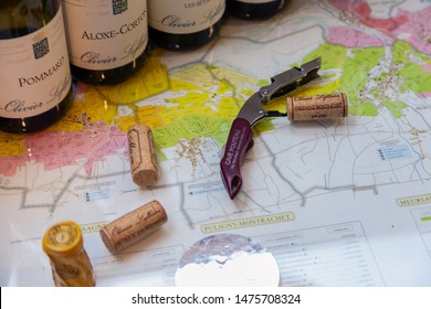 France Lyon 2019-06-20 line wine bottles closeup burgundy top wine, Pommard, Chassagne-Montrachet, professional wine tasting of the brand Olivier Leflaive, sommelier knife, opener, corks, region map
