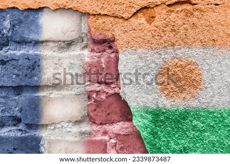 France and Niger. Nigerian and French flag. Flags of countries on background of brick wall. Street art. Former colonies of European countries.