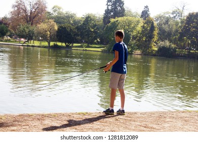 France, Paris - 24 September 2017: Bois De Boulogne. Teen Angling In A Park Pond