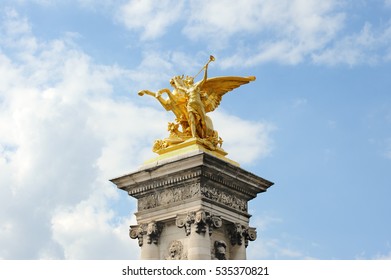 FRANCE, PARIS - JULY 30, 2014: Golden figure of Pegasus and angels on the Bridge Alexander III against the blue sky. 