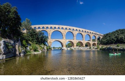 FRANCE PONT DU GARD, SEP 2018 People Paddling In A Canoe Near The Pont Du Gard, Ancient Roman Aqueduct