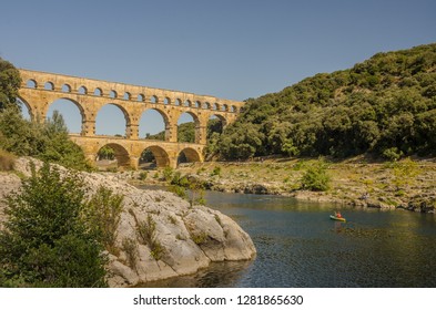 FRANCE PONT DU GARD, SEP 2018 People Paddling In A Canoe Near The Pont Du Gard, Ancient Roman Aqueduct