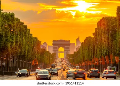 France. Summer evening in Paris. Traffic on the Champs-Elysees and the Arc de Triomphe. Golden sunset
