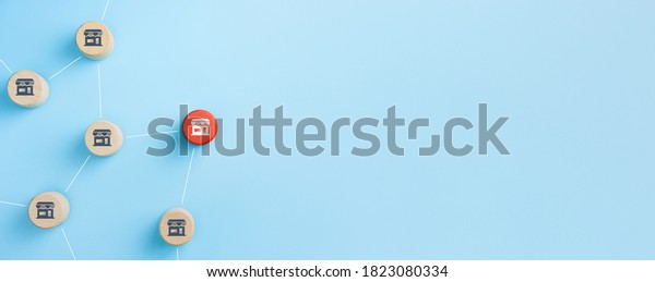 Franchise business\
marketing system concept with wooden cubes with franchise icons on\
blue background, copy\
space