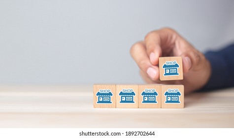 Franchise business,Businessman hand choose wooden blog with franchise marketing icons Store. Franchise business concept. - Shutterstock ID 1892702644