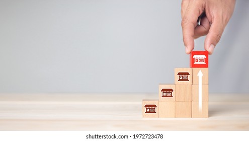 Franchise business,Businessman hand choose wooden blog with franchise marketing icons Store. Franchise business concept. - Shutterstock ID 1972723478