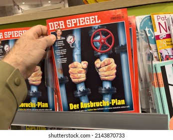 Frankfurt, Germany - Ap 2, 2022: POV Male Hand Holding In Newspaper Kiosk Latest Edition Of The Der Spiegel German Magazine With The Title The Escape Paln From Gazprom