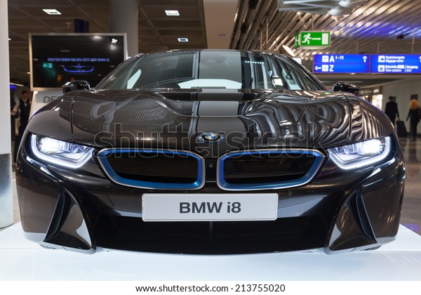 FRANKFURT, GERMANY - AUGUST 28, 2014: Photo of\
black BMW series i8 innovation car. Advertising stand in the\
passenger terminal, airport of\
Frankfurt